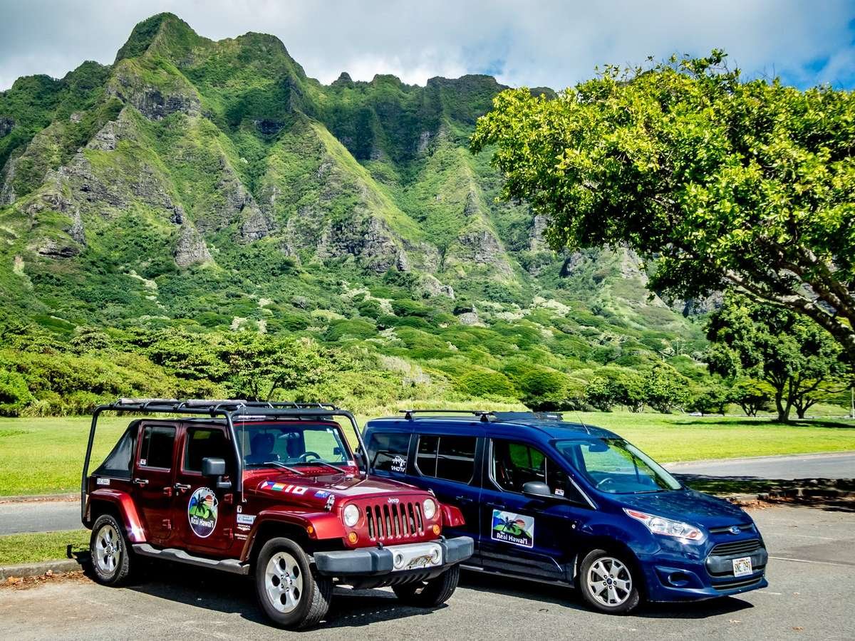 The Real Hawai'i Jeep and van parked below the Ko'olau mountains
